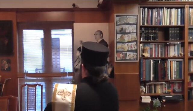 Ιερέας αγιάζει το πορτρέτο του Κ. Καραμανλή στο γραφείο του Νικολόπουλου