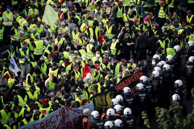 Αστυνομικοί φυλάνε σκοπιά απέναντι από διαδηλωτές πριν από την έναρξη του συνεδρίου της Εναλλακτικής για τη Γερμανία (AfD) στο Έσσεν της Γερμανίας