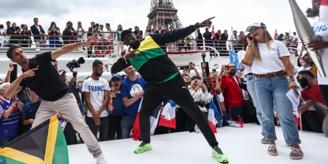 Ο Τζαμαϊκανός «συνταξιούχος» σπρίντερ Usain Bolt και ο πρόεδρος της Οργανωτικής Επιτροπής του «Παρίσι 2024» Tony Estanguet εκτελούν την χαρακτηριστική κίνηση του Bolt κατά τη διάρκεια παρέλασης. Θα σπάσει κάποιος τα ρεκόρ του;